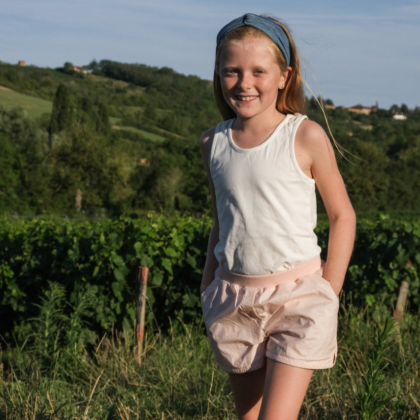 Little Hedonist organic cotton shorts with side pockets and splits for boys and girls in Evening Sand