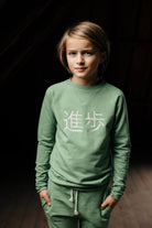 Little Hedonist Jade minimalistic sweater made of the softest organic babysweat you can imagine, with a soft 3D print noting Progress in Japanese.