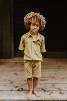 Super soft Little Hedonist gold organic button down shirt for boys and girls. Sustainable unisex kids clothing made from organic cotton.