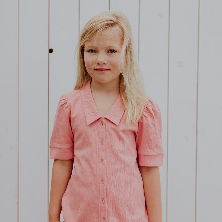 Little Hedonist puff sleeve blouse in Coral Almond for girls. This button down shirt is made from organic cotton. Sustainable kids clothing.