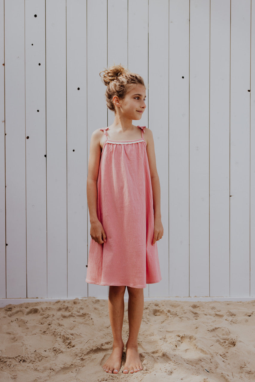 Little Hedonist light beach dress in coral. The must have beach dress for girls! Sustainable kids clothing made from organic cotton.